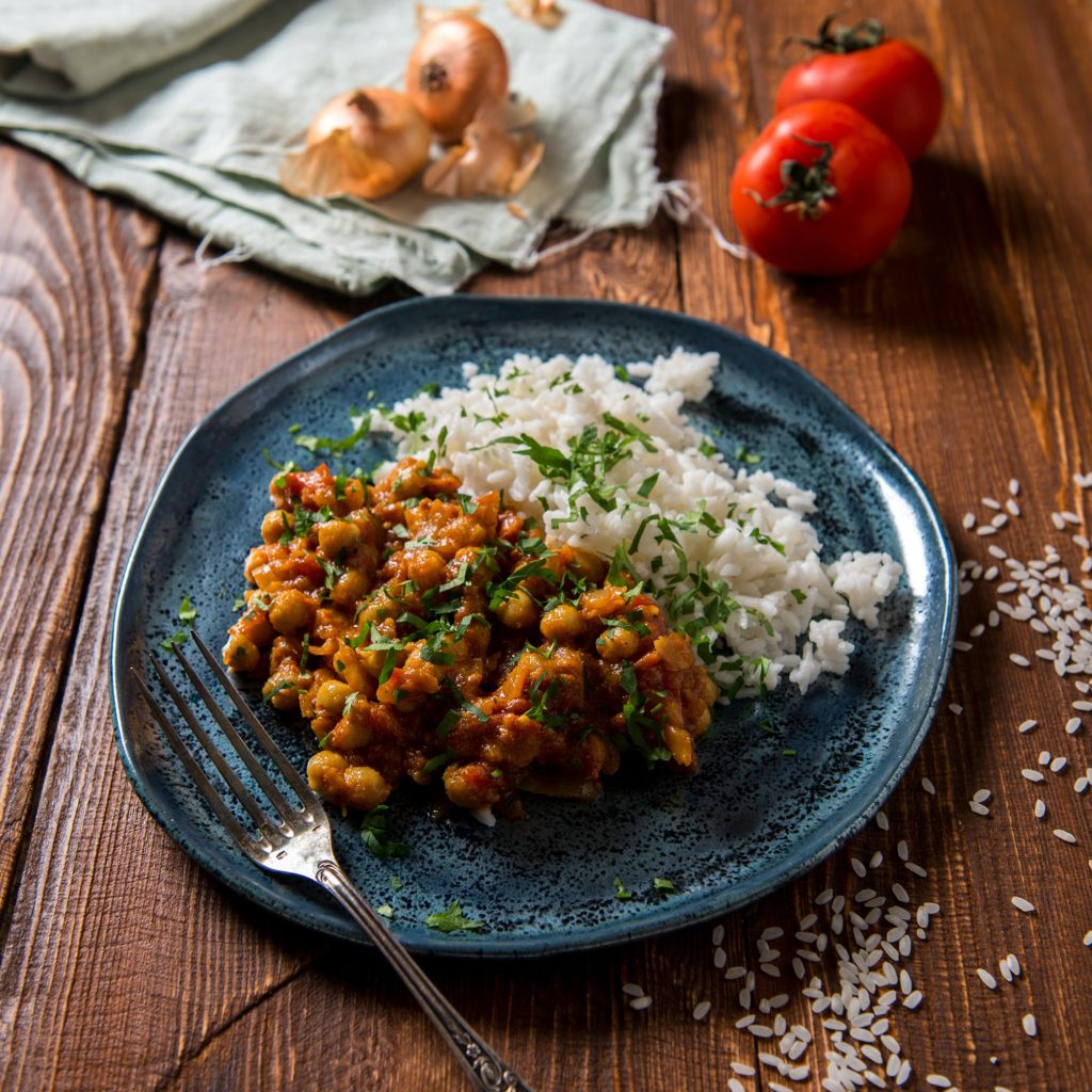 Garbanzo beans (aka, chickpeas) in sauce with a side of rice. These two foods (a legume combined with a grain) make a complete protein meal!