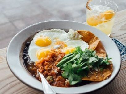 Eggs with beans, rice, lettuce, and a tortilla to make a high-protein vegetarian breakfast!